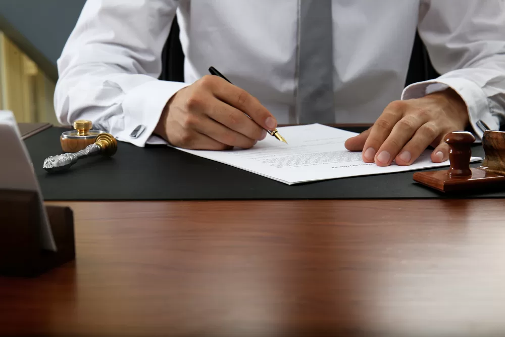 Photo of a man writing papers on the desk