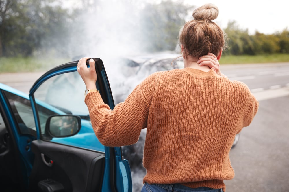 Woman holding her neck after a car crash