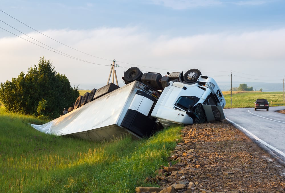 White car in a ditch