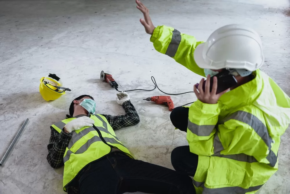 Construction worker helping a coworker after a construction accident