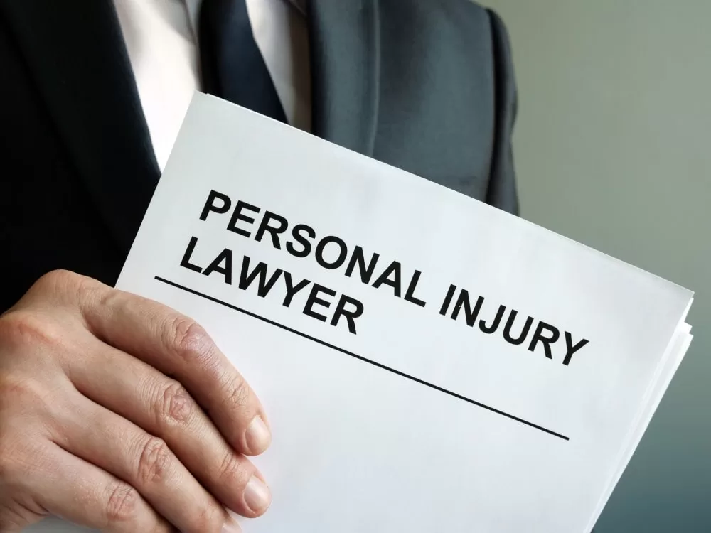 A closeup of an attorney holding personal injury case papers in hand