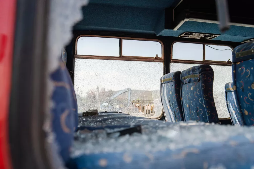 Interior seats with broken windows of the wrecked bus