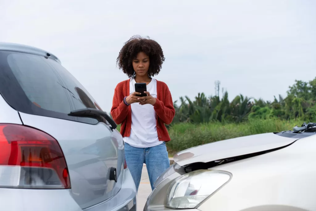 Driver check for damage after a car accident before taking pictures and sending insurance