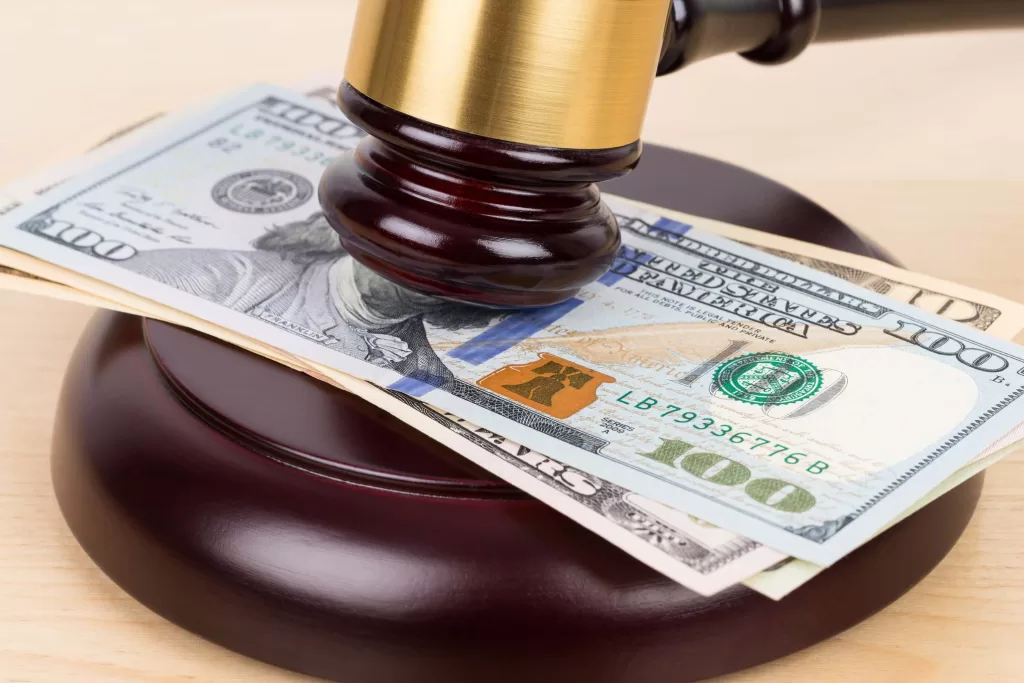 Judge wooden gavel with dollar money banknote concept for bribery